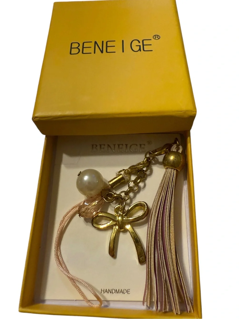 BENEIGE handmade bow and pearl bag charm featuring a gold-toned bow accent